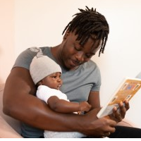 father reading to his baby